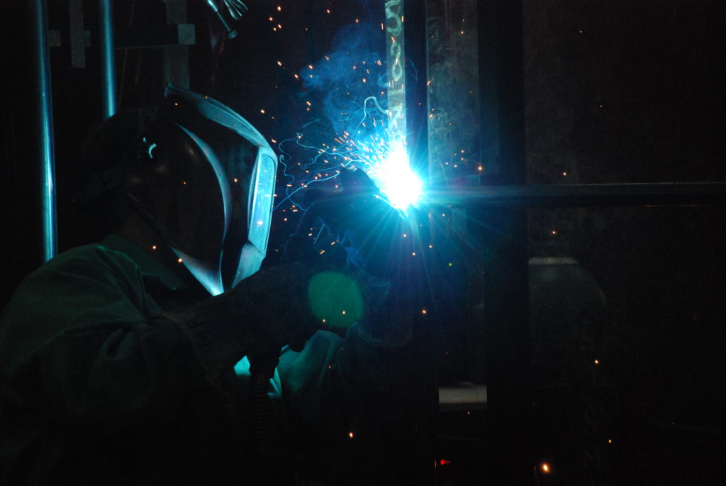 A welder finishes up a GT silencer in Arcadia WI.